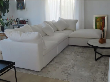 Comfortable white Foam Cloud Modular Sectional Sofa arranged in an L-shape in a bright living room